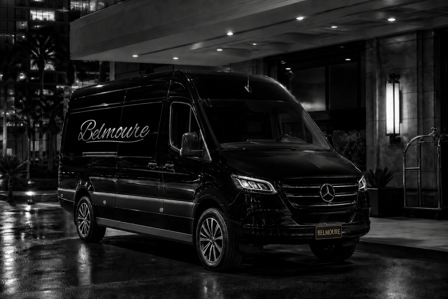 Black Mercedes-Benz Sprinter with white Belmoure branding and gold BELMOURE license plate